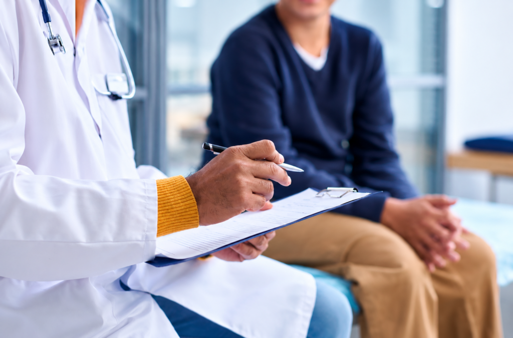 Doctor reviewing health data on a tablet with a patient