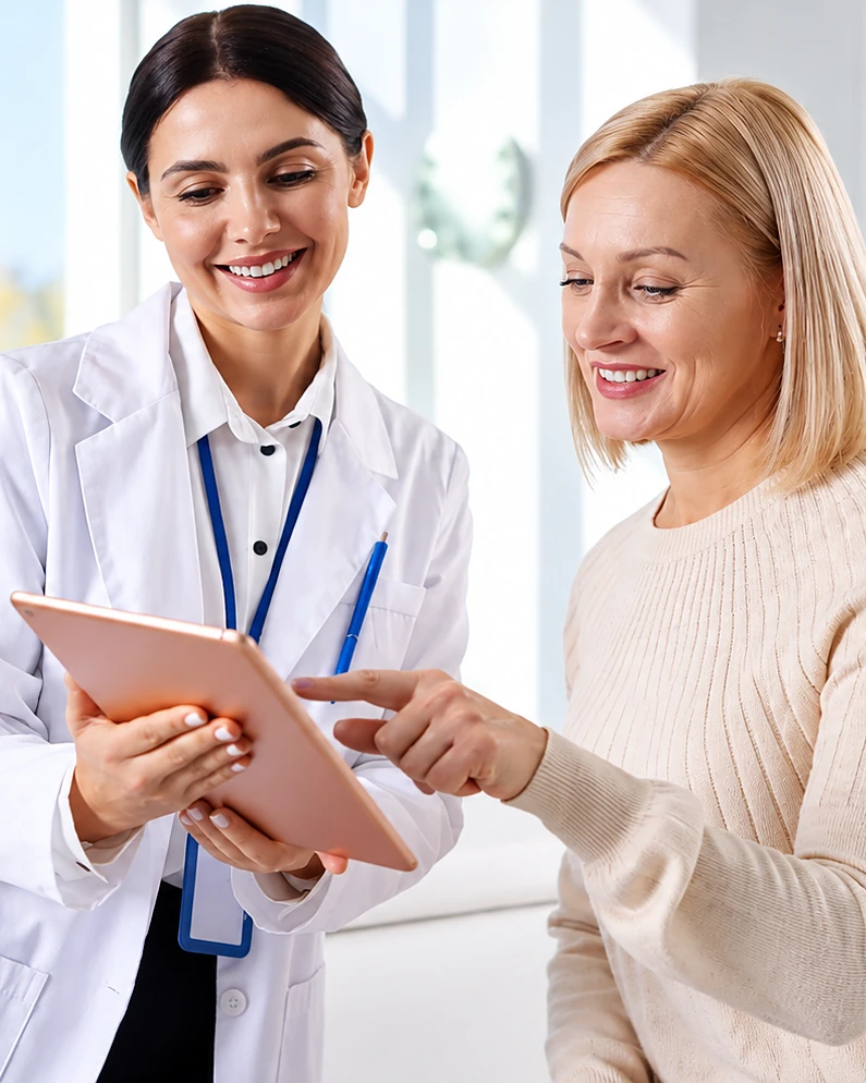 Doctor reviewing health data on a tablet with a patient